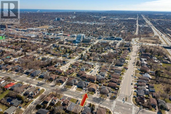 Aerial view of Hamilton neighborhood showing residential streets and highway interchange. - 729 West 5th Street, Hamilton