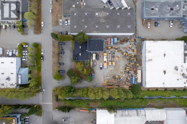 Overhead view of the commercial property at 7293 Wilson Avenue, showing buildings, parking, and adjacent industrial sites. - 7293 Wilson Avenue, Delta