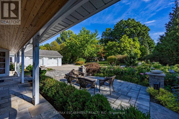 View from covered porch overlooking patio with outdoor seating and fire pit. - 73 & 75 Prospect Street, Norfolk