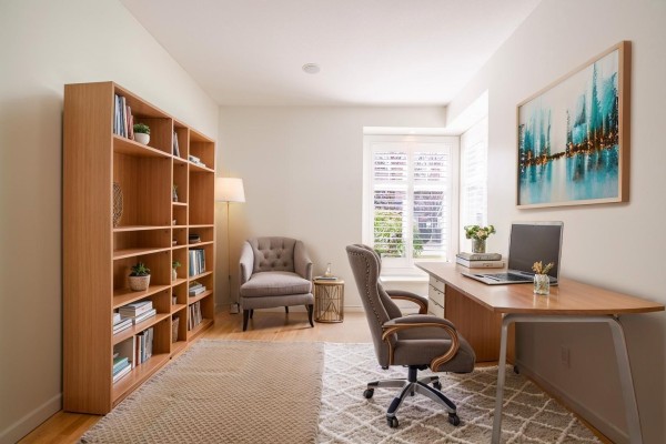 Living room with a light beige sectional sofa, armchair, wooden coffee table, and fireplace. - 73 15715 34 Avenue, Surrey