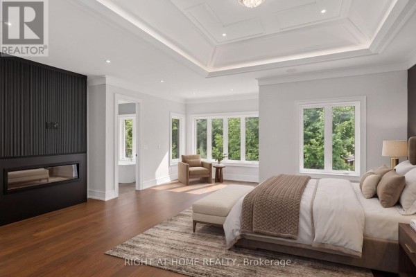 Bedroom with linear fireplace, coffered ceiling, and large windows - 73 Harding Boulevard Richmond Hill