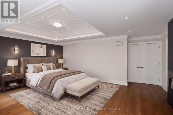 Bedroom with coffered ceiling, tufted headboard, bench, and hardwood floors - 73 Harding Boulevard Richmond Hill