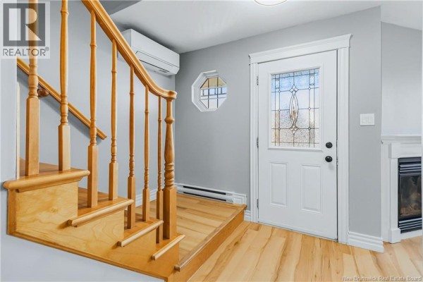 Interior view of a wooden staircase with white spindles, leading to a landing with a white door. - 73 Sawgrass Drive, Riverview