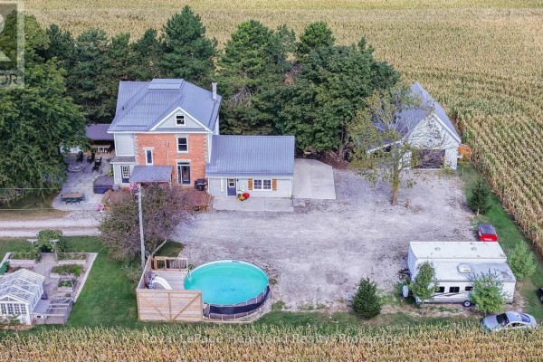 Aerial view of a farmhouse complex including a pool, garage, trailer, and outbuildings. - 73080 Airport Line, Bluewater