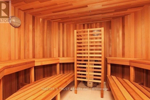 Wooden sauna with tiered benches, heater, and ventilation screen. - 731 - 39 Queens Quay E, Toronto