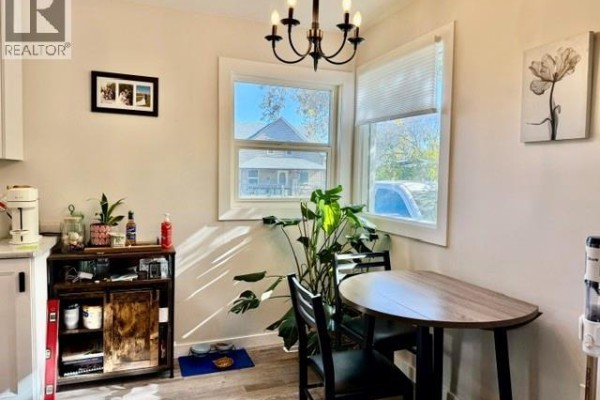 Kitchen nook with a round table, chairs, and windows overlooking the street. - 731 13th Street, Humboldt