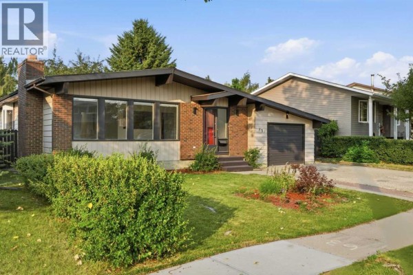 Front exterior view of the residence with well-maintained landscaping and a concrete driveway. - 731 Queensland Drive Se, Calgary