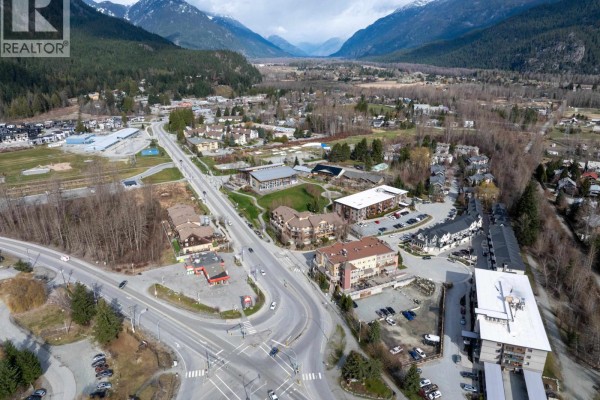 Aerial view of Pemberton's commercial and residential areas, featuring a valley and mountain backdrop. - 7340 Crabapple Court, Pemberton