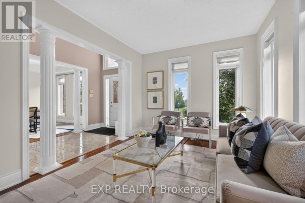 Outdoor deck with wooden railing, brick exterior, and landscaped yard - 735 Foxcroft Boulevard, Newmarket