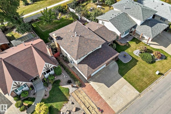 Aerial view of the property showing the house, driveway, and surrounding homes. - 7355 18 Av Nw, Edmonton