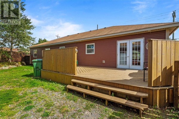 Wooden deck with stairs and French doors leading from the backyard to the house. - 738-742 Ville Marie Drive, Marystown