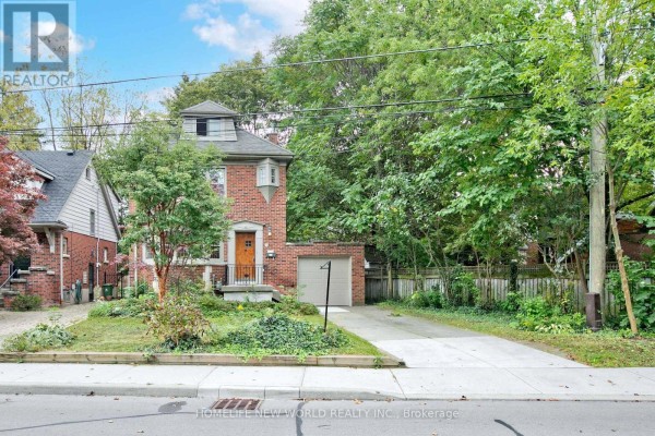 Exterior view of a brick house with a driveway and garage on a wooded lot. - 74 Haddon Avenue N, Hamilton