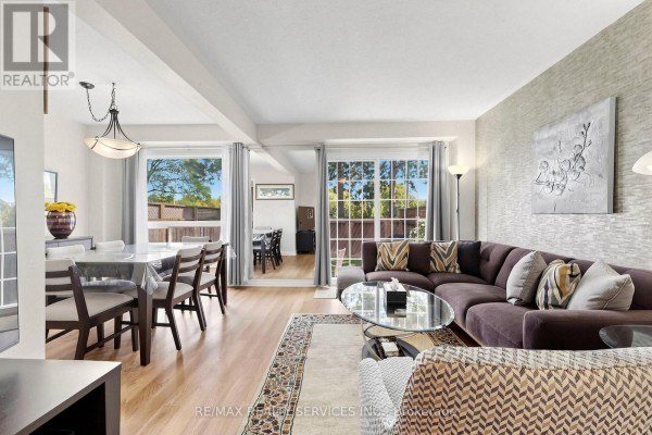 Foyer with a white door with stained glass, wood bench, coat rack, and a tall window with blinds. - 74 Heathcliffe Square, Brampton