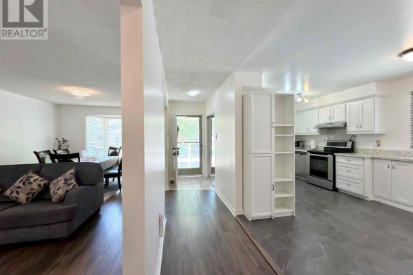 Dining room with a large bay window, dark wood chairs, and a table set for six. - 74 Tumbleweed Crescent, London South