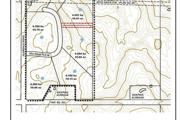 Aerial view of green land with outlined property boundaries and a small pond near the road. - 74.7ac Glendale Road, Rural Rocky View County