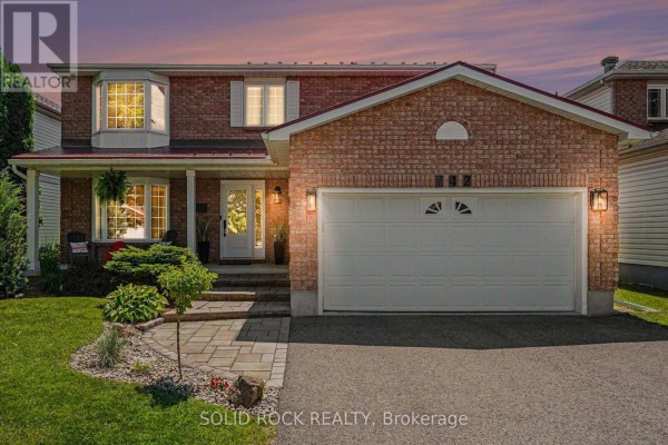 Front exterior view of a brick house with a white garage door at dusk. - 742 Merkley Drive, Ottawa