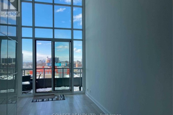 Interior room with floor-to-ceiling windows and a view of the city skyline. - 743 - 5 Hanna Avenue, Toronto