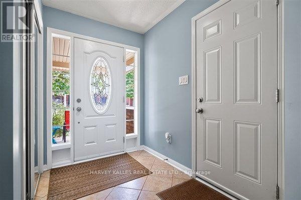 Interior entryway with light blue walls, white doors, and tiled floor. - 745 Challinor Terrace, Milton