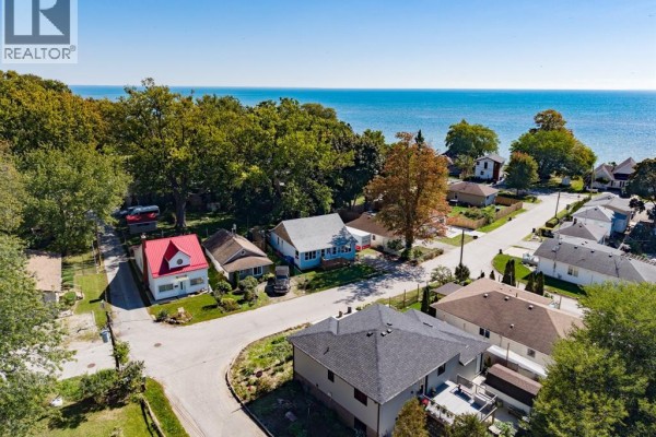 Aerial view of houses near the water with trees and blue sky. - 748 Scratch Lane, Kingsville