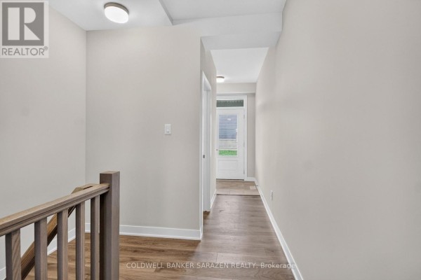 Kitchen with gray wood cabinets, granite countertops, and a large island with a sink. - 749 Haflinger Row, Ottawa