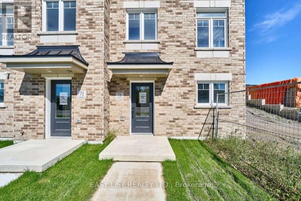 Close-up exterior view of two townhouse entrances with brick facade and concrete steps. - 75 Addyman Crescent, Clarington
