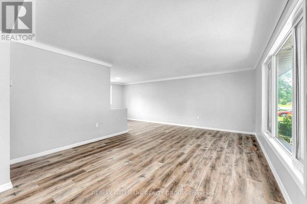 Interior hallway view towards laundry room with red washer and dryer. - 75 Briscoe Street, Loyalist
