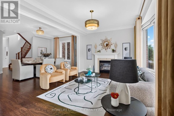 Living room featuring a fireplace, plush yellow chairs, and a sectional sofa with a large rug. - 75 Estrella Crescent, Richmond Hill