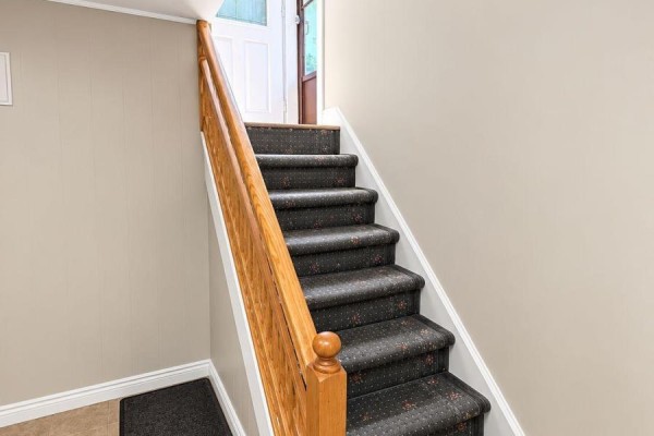 Carpeted staircase with wooden handrail leading upwards. - 75 Kootenay Crescent, Toronto