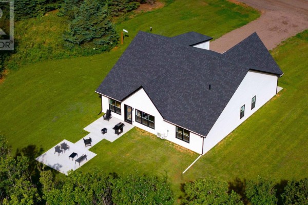 Aerial view of the rear of a modern white house with a large patio. - 75 Oceanlinks Lane, West St  Peters