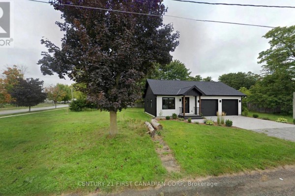 Two-story brick and siding house with a grey facade, a double garage, and manicured landscaping. - 750 Havelock Street N, Huron Kinloss