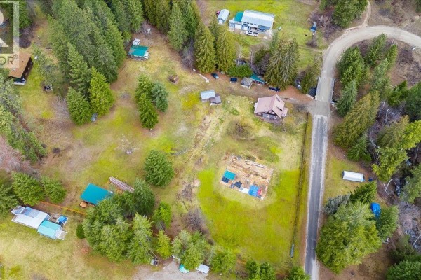 Aerial view of wooded area with scattered buildings and a road. - 7515 Broadwater Road, Deer Park