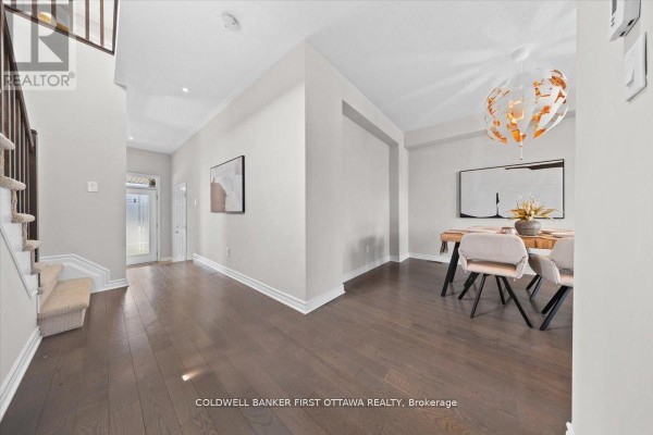 Kitchen with white countertops, dark wood cabinets, and stainless steel appliances. - 754 Brian Good Avenue, Ottawa