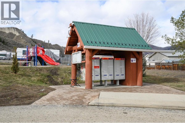 Wooden mail station with green roof and multiple mailboxes. - 7545 Dallas Drive Unit# 54, Kamloops