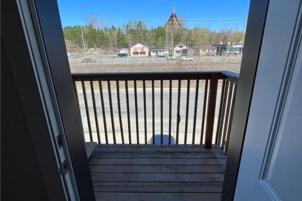 View from balcony looking over Ontario Street towards buildings and a steeple. - 755 Ontario Street, Sudbury