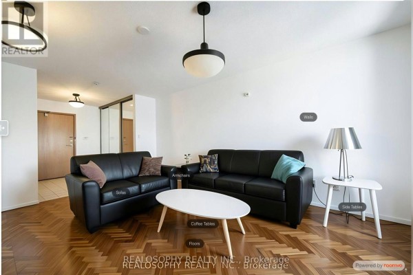 Living room with red sofas, a wooden coffee table, and parquet flooring. - 756 - 24 Southport Street, Toronto