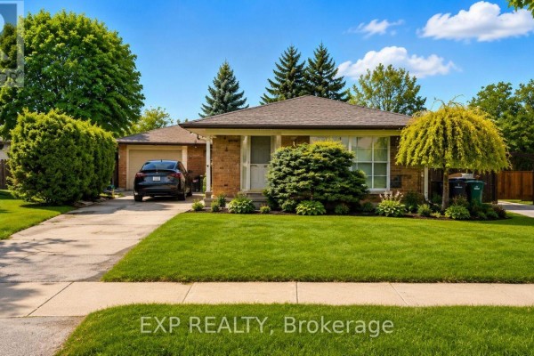 Front exterior of a single-story brick house with a well-maintained lawn and trees. - 76 Appalachian Crescent, Kitchener
