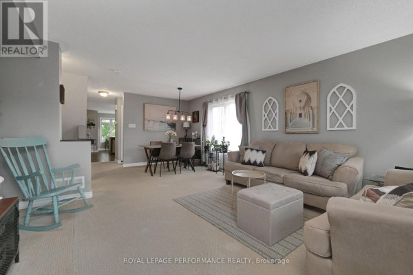 Living and dining area with neutral furniture, a dining table, and carpeted floor. - 76 Argent Private, Ottawa