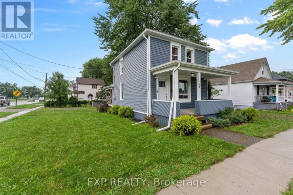 Blue house with covered front porch and white trim - 76 Bell Street Port Colborne