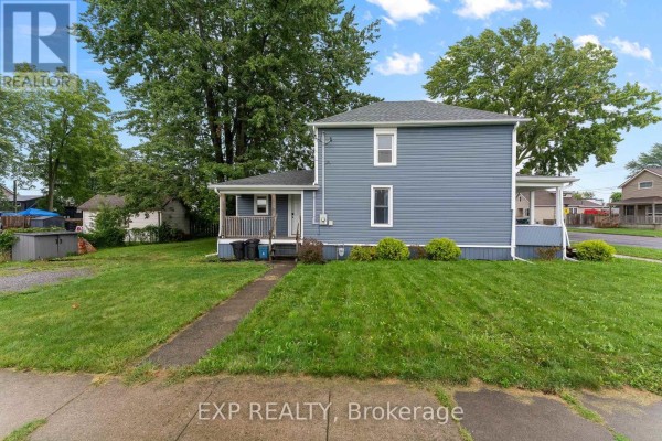 Blue siding house with front porch and lawn - 76 Bell Street Port Colborne