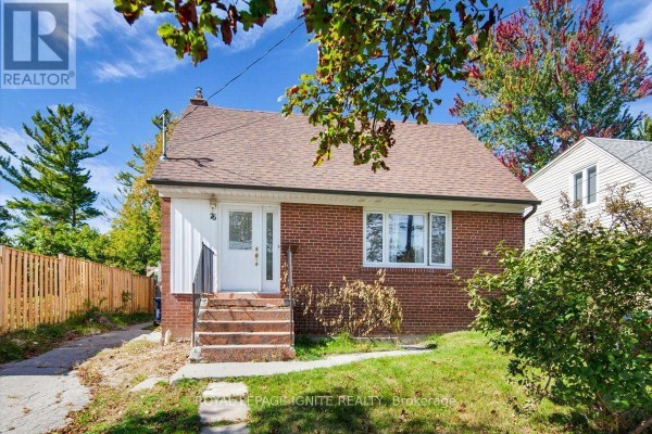 Exterior front view of a red brick detached house with a prominent chimney. - 76 Celeste Drive, Toronto