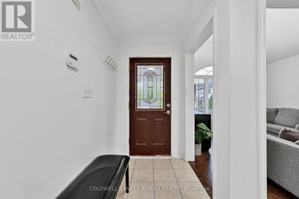 A wicker sofa sits on the front porch with large windows. - 76 John W Taylor Avenue, New Tecumseth