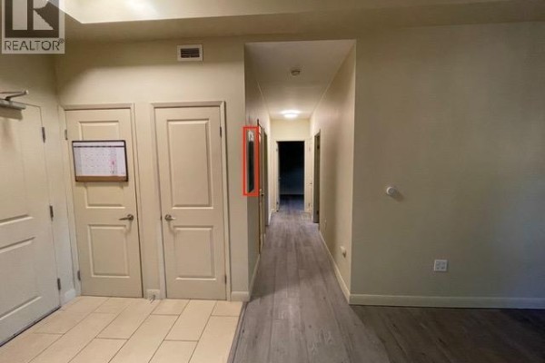 Building lobby with mailboxes, elevator, tiled floor, and a potted plant. - 76 Sydney Street S Unit# 208, Kitchener