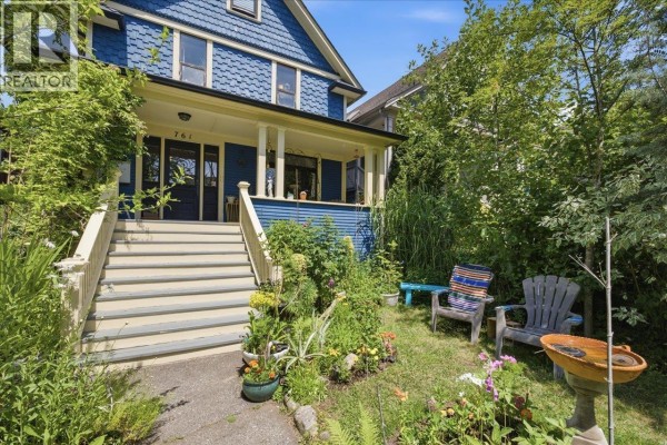 Front yard of the blue house with a porch, stairs, and seating. - 761 E 15th Avenue, Vancouver