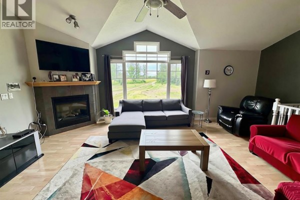 Kitchen with light wood cabinets, gray countertops, diamond patterned backsplash, and stainless steel sink. - 76317 Highway 49, Rural Smoky River No  130, M D  Of