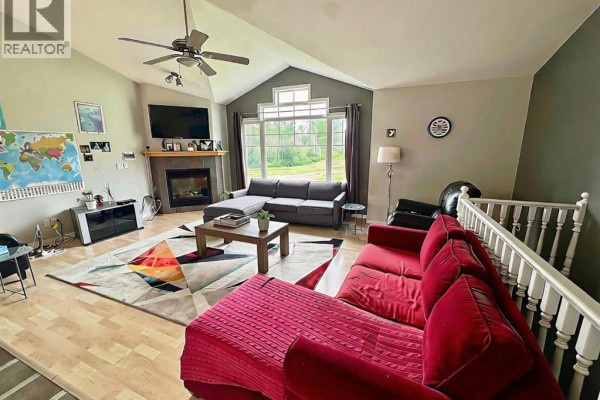 Kitchen with light wood cabinets, stainless steel appliances including a refrigerator and stove, and checkered flooring. - 76317 Highway 49, Rural Smoky River No  130, M D  Of