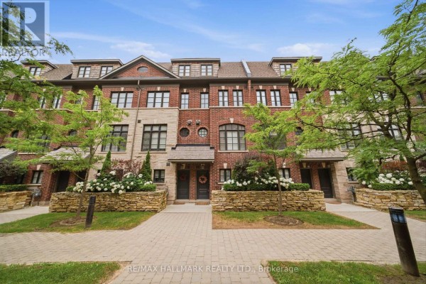 Front exterior of a townhouse complex with brick and stone facades. - 77 - 250 Royalton Common, Oakville