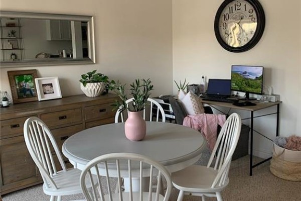 Dining area with a round grey table, four white chairs, and a desk with a computer. - 77 Diana Avenue Unit# 158, Brantford