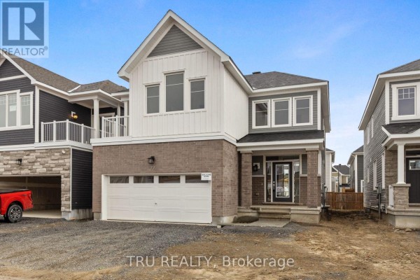 Close-up of the front entrance showing a brick porch with a glass-paneled front door and gray siding. - 77 Hackamore Crescent, Ottawa