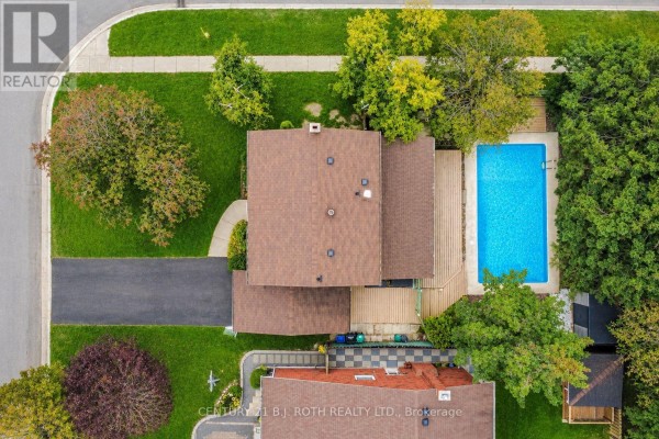 Aerial view of a residential house with a brown roof and an in-ground swimming pool. - 77 Pepler Place, Barrie