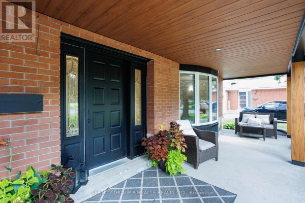 Detailed view of the front door area with covered porch, seating, and bay window. - 77 Sanderling Crescent, Kawartha Lakes